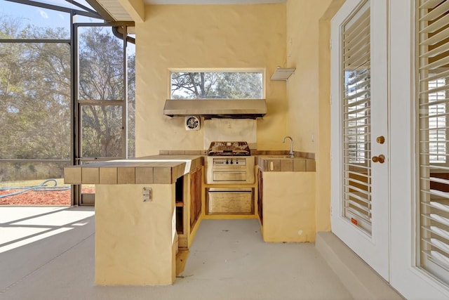 view of patio featuring area for grilling and sink