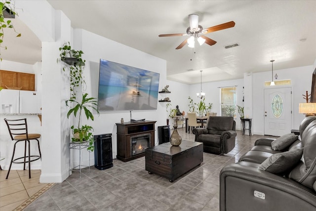 living room with ceiling fan and tile patterned floors