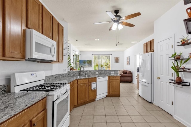 kitchen with white appliances, sink, kitchen peninsula, ceiling fan, and light tile patterned floors