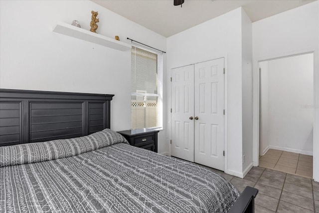 bedroom with ceiling fan, a closet, and light tile patterned flooring