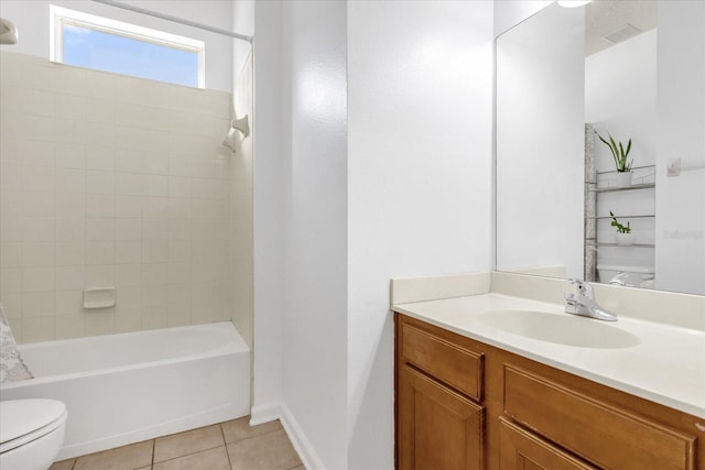 full bathroom with tile patterned floors, toilet, vanity, and tiled shower / bath