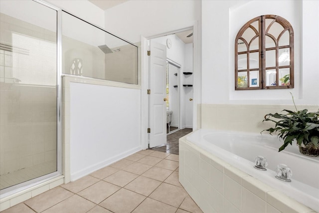 bathroom with independent shower and bath and tile patterned floors