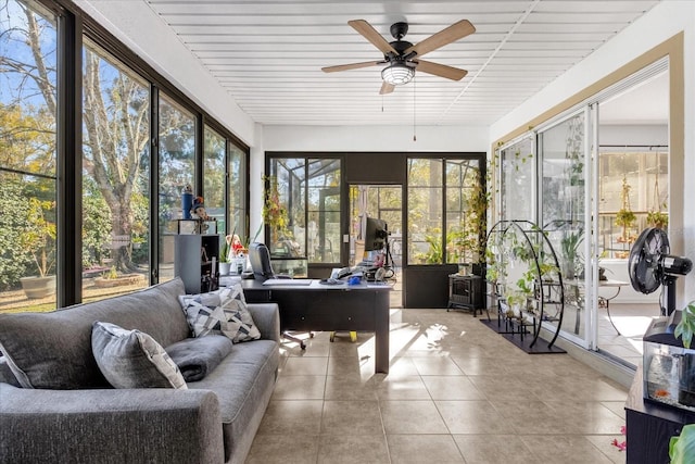 sunroom / solarium featuring ceiling fan and a wealth of natural light