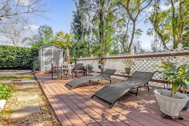 wooden terrace featuring a storage shed