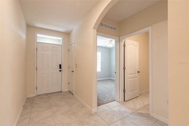 tiled entrance foyer featuring ceiling fan