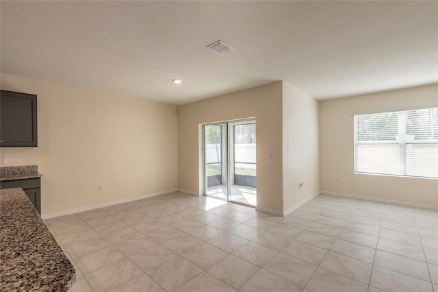 unfurnished living room featuring light tile patterned flooring