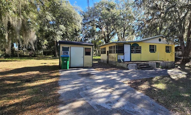 view of front of house with a storage unit