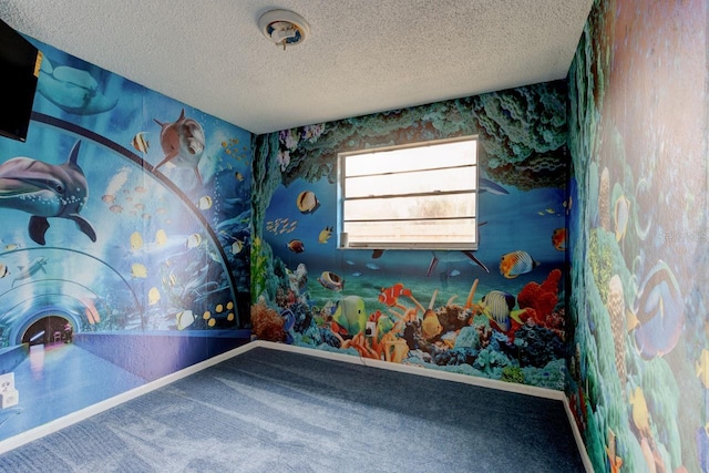 recreation room featuring carpet floors and a textured ceiling