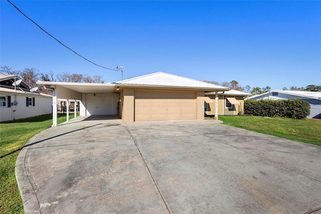 single story home with a front lawn, a carport, and a garage