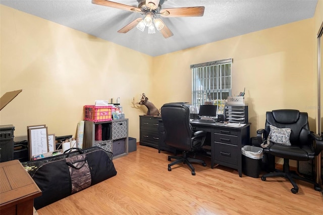 office area with light hardwood / wood-style floors, a textured ceiling, and ceiling fan