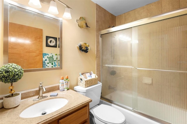 full bathroom with toilet, enclosed tub / shower combo, and vanity