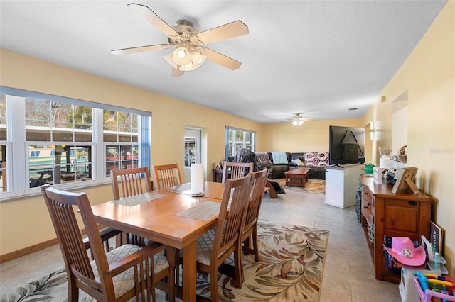 dining room with ceiling fan and light tile patterned flooring