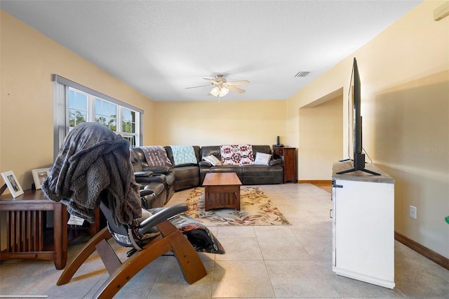 living room with ceiling fan and light tile patterned floors