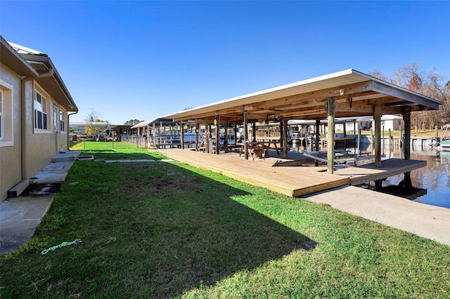 view of dock featuring a lawn