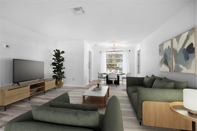 living room featuring a textured ceiling and wood-type flooring