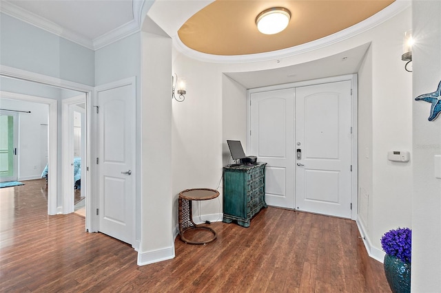 foyer entrance with dark hardwood / wood-style flooring and ornamental molding