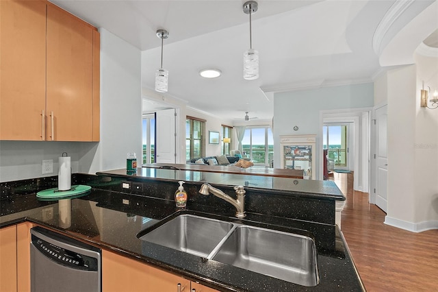 kitchen with decorative light fixtures, stainless steel dishwasher, crown molding, and dark stone countertops