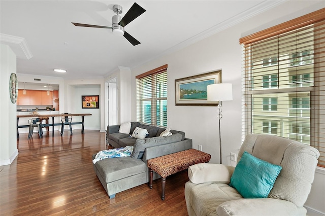 living room featuring hardwood / wood-style flooring, crown molding, and ceiling fan