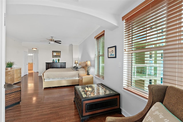 bedroom with ceiling fan, dark hardwood / wood-style flooring, and ornamental molding