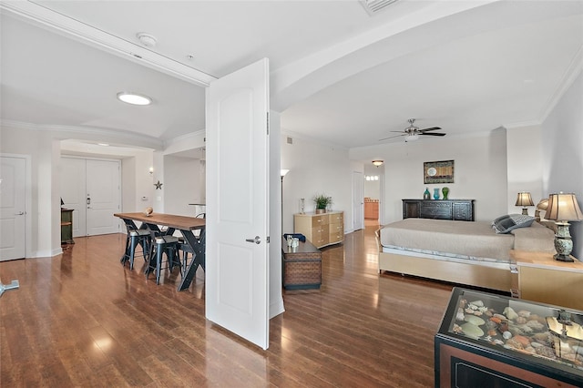 bedroom featuring crown molding and dark hardwood / wood-style floors