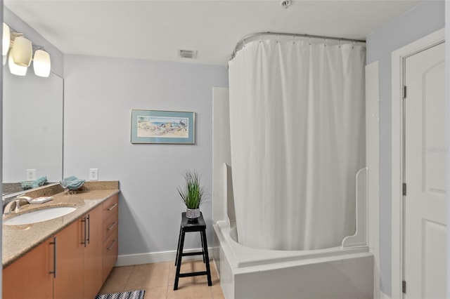 bathroom featuring tile patterned flooring, shower / tub combo, and vanity