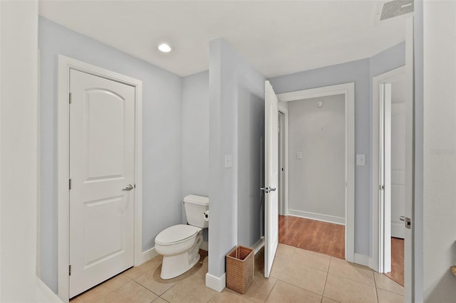 bathroom with toilet and tile patterned flooring