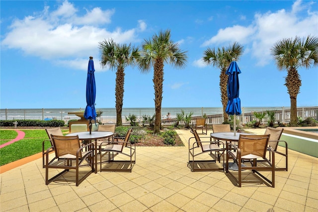 view of patio featuring a water view and a view of the beach