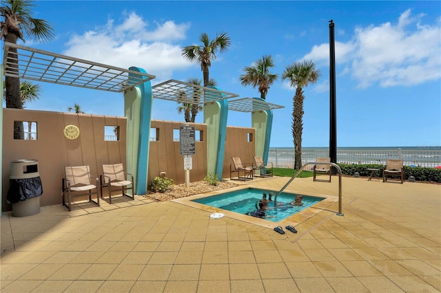 view of swimming pool featuring a water view and a patio