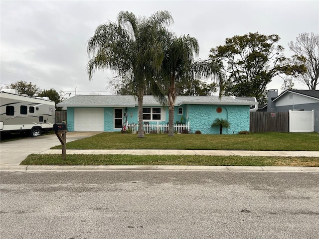 ranch-style house with a garage and a front yard