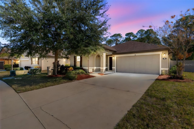 view of front of home with a yard and a garage