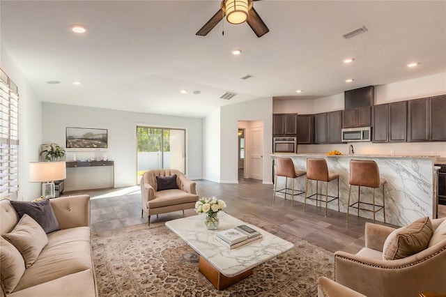 living room featuring ceiling fan and wood-type flooring