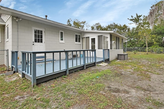 back of house with a wooden deck and a sunroom