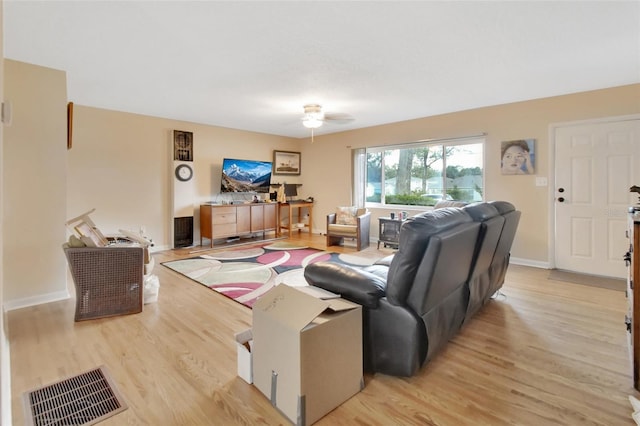 living room featuring ceiling fan and light wood-type flooring