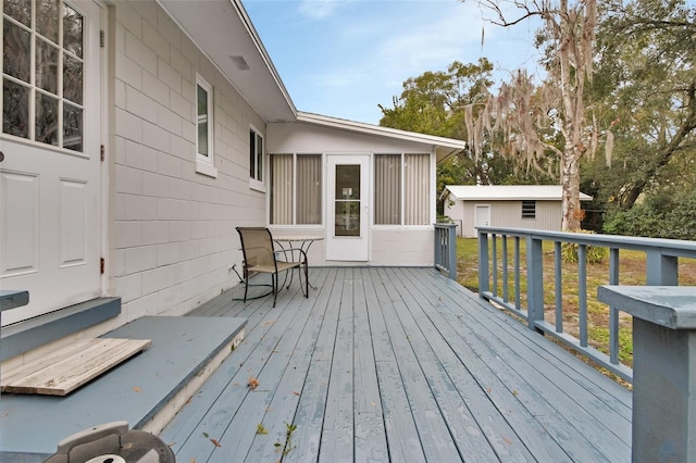 wooden deck featuring an outbuilding