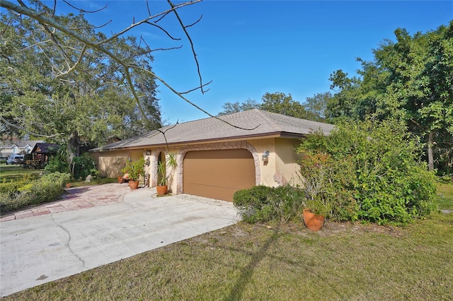 ranch-style home with a garage and a front lawn