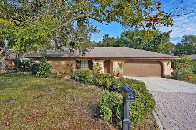 ranch-style house featuring a garage and a front lawn