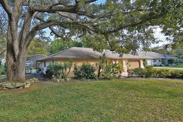 view of front of home with a lanai and a front yard