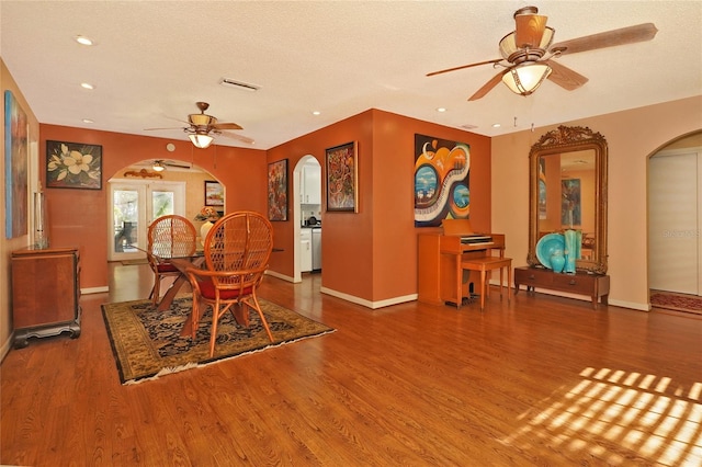 dining room featuring ceiling fan, wood-type flooring, and a textured ceiling