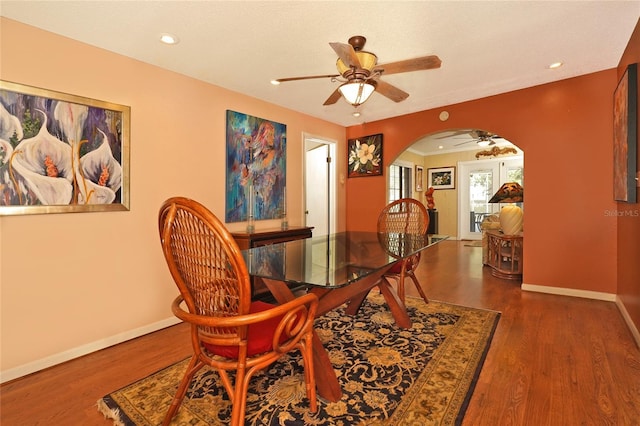 dining area with dark hardwood / wood-style floors and ceiling fan