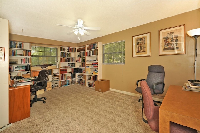 office featuring ceiling fan, light colored carpet, and a textured ceiling