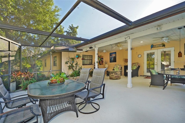 view of patio featuring a lanai, ceiling fan, and french doors