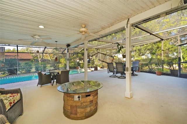 view of patio / terrace with ceiling fan and glass enclosure