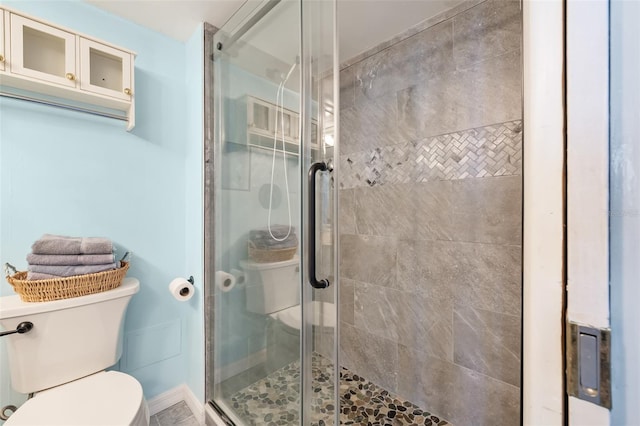 bathroom with toilet and walk in shower