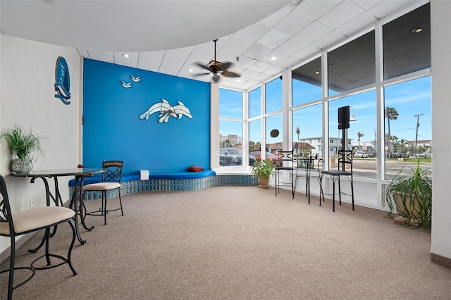 interior space with ceiling fan and carpet flooring