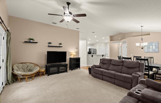 living room featuring ceiling fan with notable chandelier, light carpet, and lofted ceiling