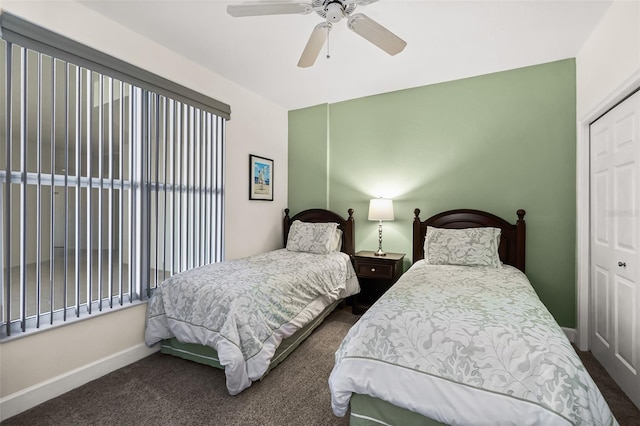 bedroom with ceiling fan, a closet, and dark carpet