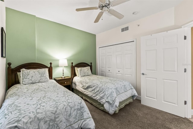 bedroom featuring ceiling fan, a closet, and dark colored carpet