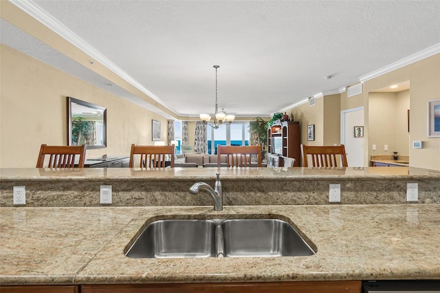 kitchen featuring crown molding, pendant lighting, a breakfast bar, and sink