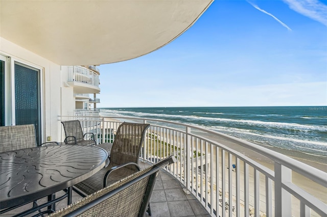 balcony with a view of the beach and a water view