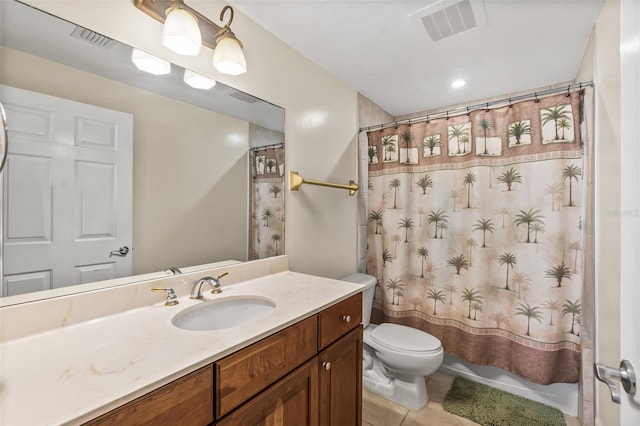 bathroom with toilet, tile patterned floors, and vanity